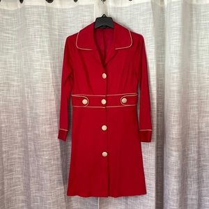Bright red trench coat with tan buttons and piping
